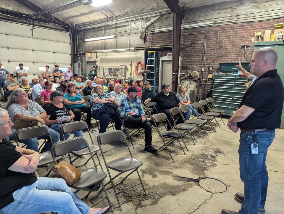 Jereme Kent, CEO of One Energy, dressed in black, speaks to a crowd of about 100 people in York Township, discussing the Whirlpool Clyde solar and wind farm project.