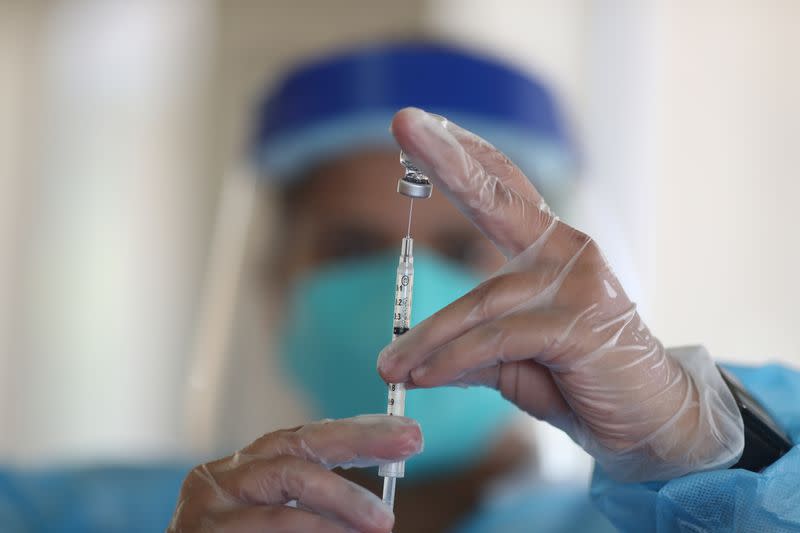 FILE PHOTO: A healthcare worker draws the coronavirus disease (COVID-19) vaccine from a vial at Mission Commons assisted living community in Redlands