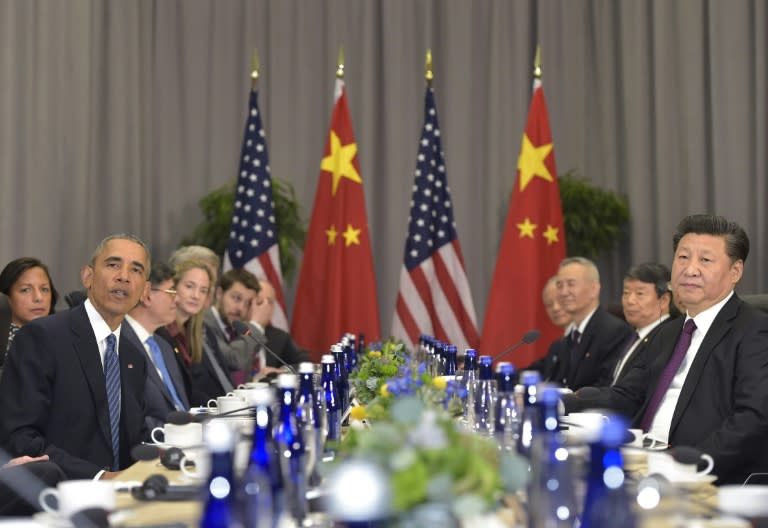 US President Barack Obama (L) speaks during a bilateral meeting with China's President Xi Jinping on the sidelines of the Nuclear Security Summit in Washington, DC