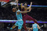 Charlotte Hornets' Cody Martin, left, dunks against Cleveland Cavaliers' Jarrett Allen during the second half of an NBA basketball game Friday, Oct. 22, 2021, in Cleveland. Charlotte won 123-112. (AP Photo/Tony Dejak)