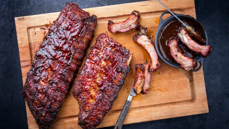 Cooked barbecued ribs on cutting board