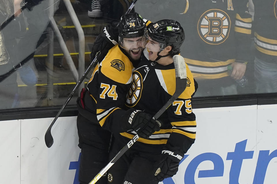 Boston Bruins left wing Jake DeBrusk (74) celebrates with defenseman Connor Clifton (75) after DeBrusk scored in the first period of an NHL hockey game against the Montreal Canadiens, Thursday, March 23, 2023, in Boston. (AP Photo/Steven Senne)