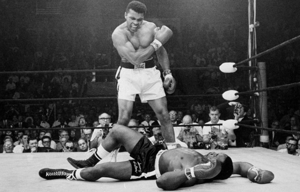 Muhammad Ali, then known as Cassius Clay, stands over Sonny Liston in their 1965 rematch