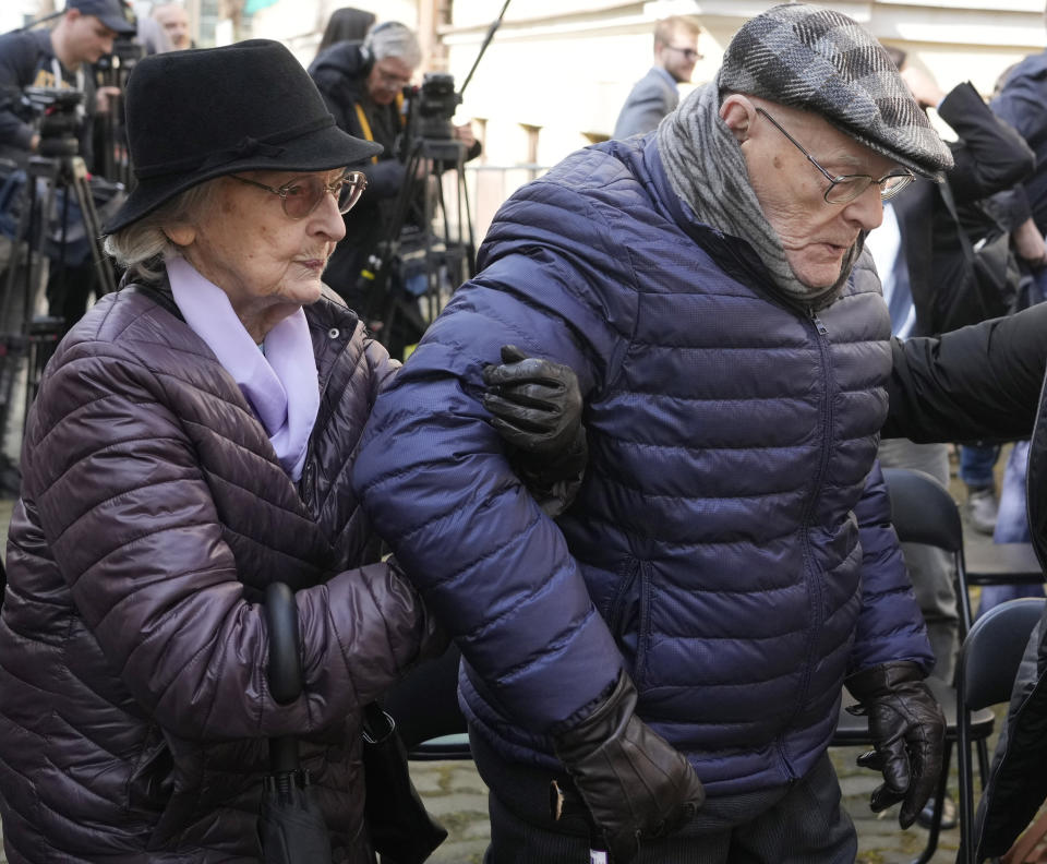 Anna Stupnicka-Bando, left, a Polish Christian honored for saving Jews, walks with Waclaw Kornblum, right, a Polish Holocaust survivor, at a ceremony for the burial of a "time capsule" on the grounds of the Warsaw Ghetto Museum in Warsaw, Poland, on Tuesday April 18, 2023. The time capsule contains memorabilia and a message to future generations. It was buried on the grounds of a former children's hospital, a building that will house the Warsaw Ghetto Museum, which is scheduled to open in three years. Tuesday's ceremony comes on the eve of the 80th anniversary of the Warsaw Ghetto Uprising, the largest single Jewish revolt against German forces during the Holocaust. (AP Photo/Czarek Sokolowski)