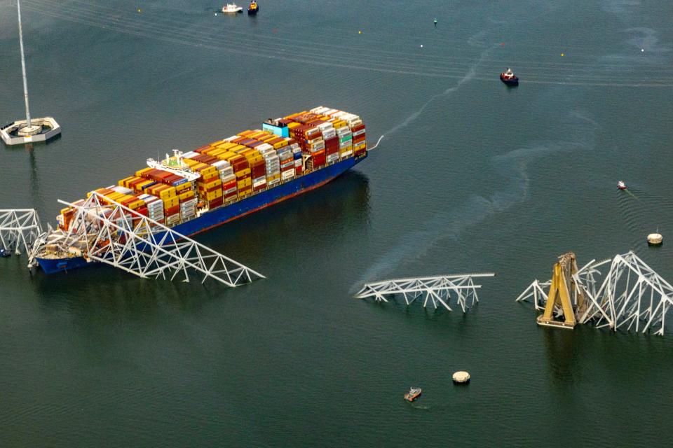 In an aerial view, the cargo ship Dali sits in the water after running into and collapsing the Francis Scott Key Bridge on March 26, 2024 in Baltimore, Maryland.