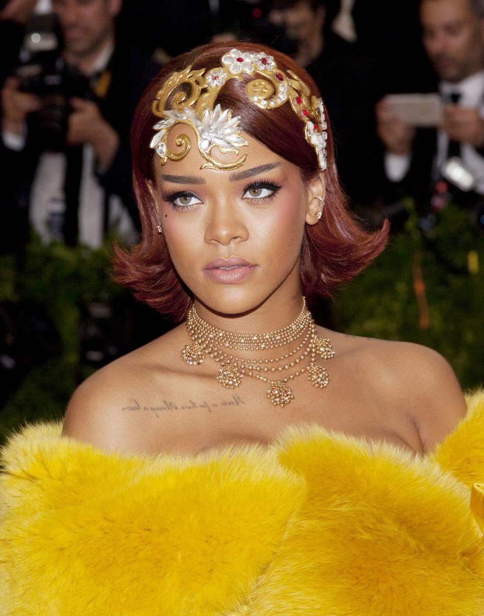 <p>To accompany her show-stopping Guo Pei gown at the 2015 Met Gala, RiRi chose a delicate rose gold and diamond Cartier necklace and topped off her look with a gilded headpiece by the Chinese couturier. </p>