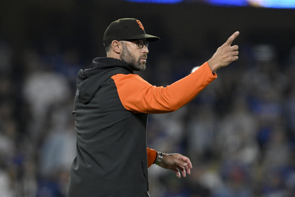 San Francisco Giants manager Gabe Kapler points to the bullpen, calling for relief pitcher Camilo Doval during the eighth inning of the team's baseball game against the Los Angeles Dodgers in Los Angeles, Friday, Sept. 22, 2023. (AP Photo/Alex Gallardo)