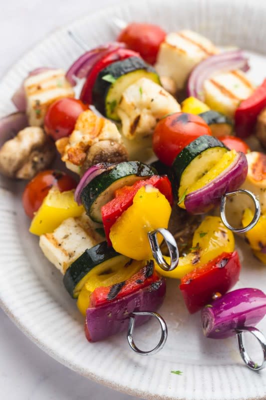 <p>Nourish Plate</p><p>These grilled veggie kabobs with halloumi are so delicious, flavorful and very easy to make! A great grilling side (or main) that everyone will love.</p><p><strong>Get the recipe: </strong><a href="https://nourishplate.com/veggie-kabobs/" rel="nofollow noopener" target="_blank" data-ylk="slk:Veggie Kabobs;elm:context_link;itc:0;sec:content-canvas" class="link rapid-noclick-resp"><strong>Veggie Kabobs</strong></a></p>