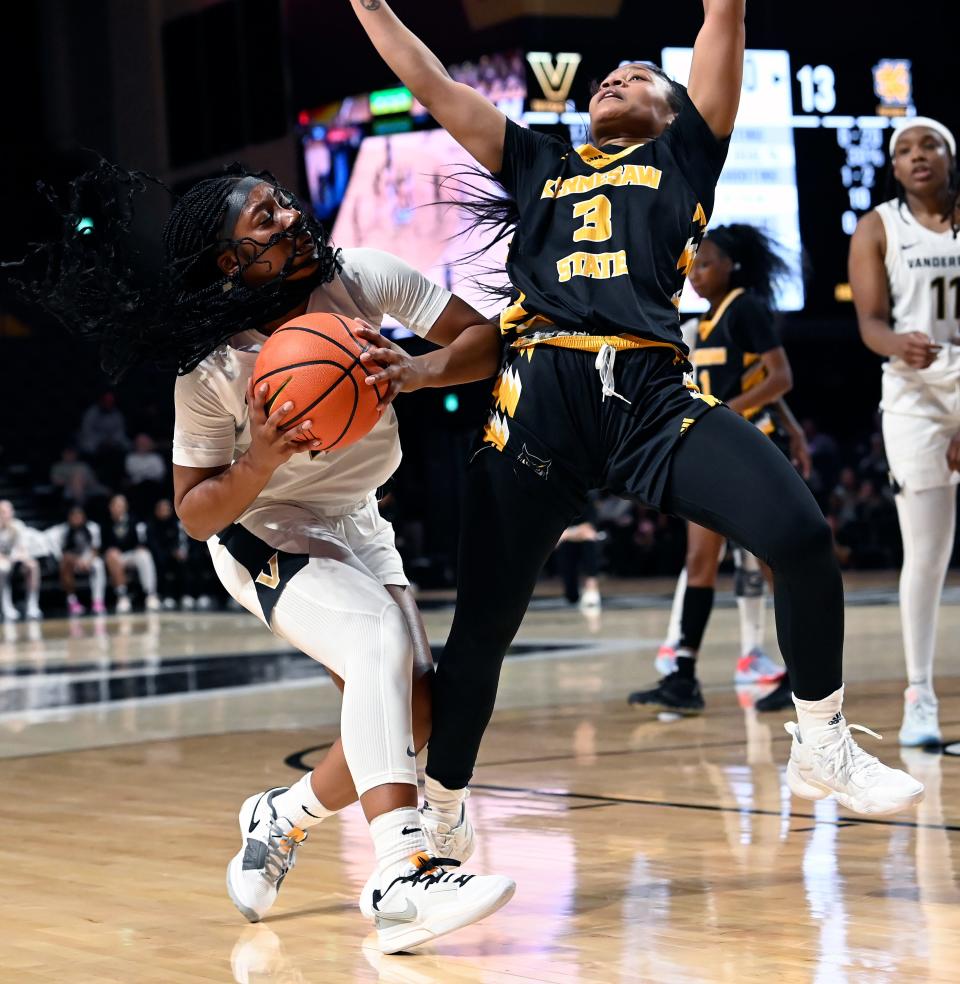 Vanderbilt guard Madison Greene, left, drives to the basket against Kennesaw State guard Lee Lee Willis (3) during the first half of an NCAA college basketball game Monday, Nov. 6, 2023, in Nashville, Tenn.