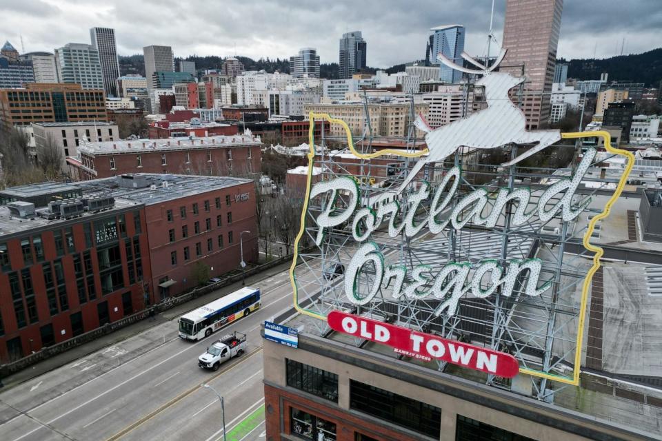PHOTO: An aerial image shows the White Stag neon sign as vehicles cross the Willamette River in downtown Portland, Oregon, Jan. 25, 2024. (Patrick T. Fallon/AFP via Getty Images)