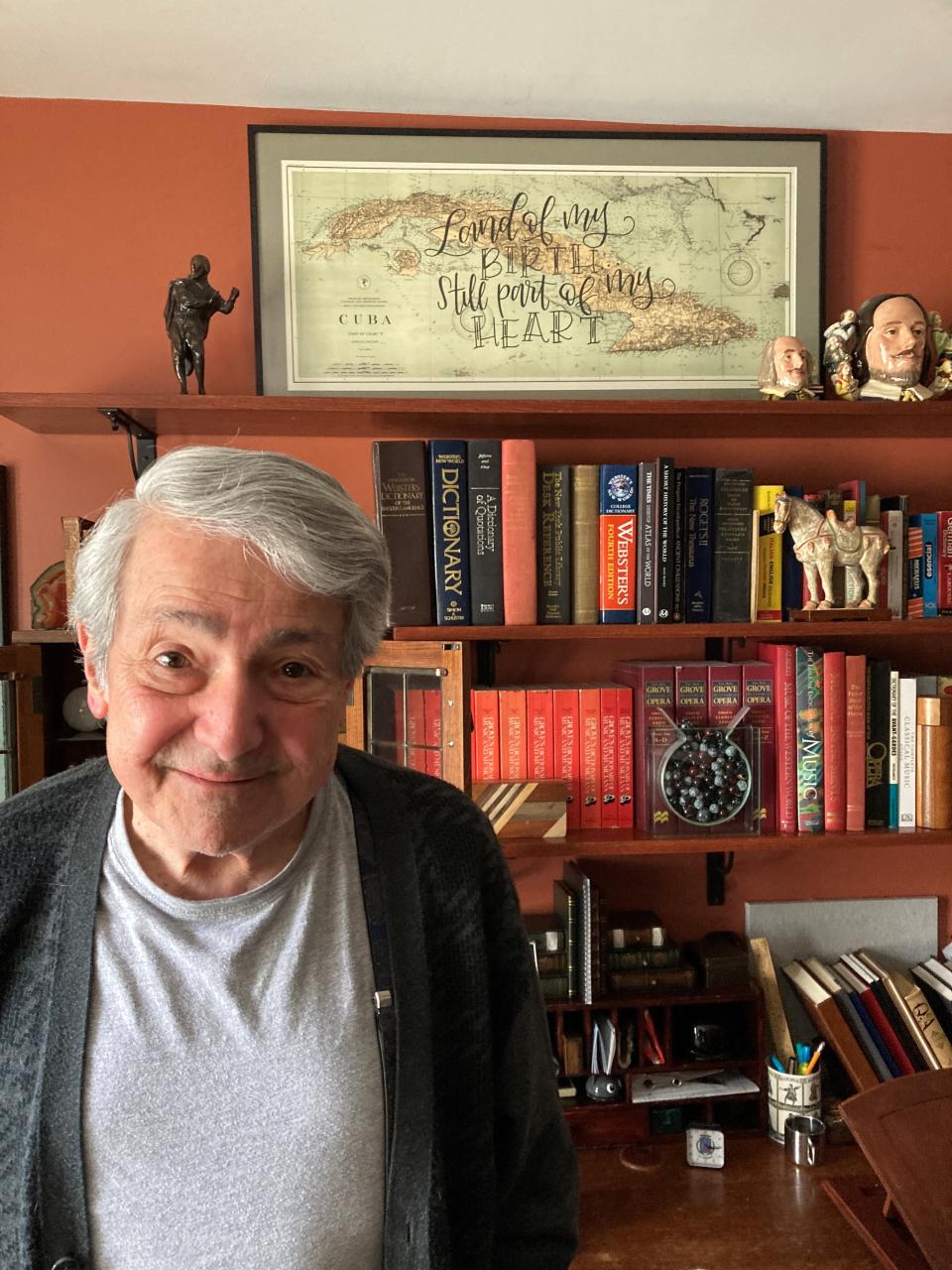 Rafael de Acha, a long-time musical performer and director, came to the United States as a teen Cuban refugee. His study has a map of Cuba that says: “Land of My Birth. Still Part of My Heart.”