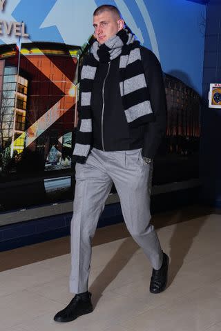 <p>Garrett Ellwood/NBAE via Getty</p> Nikola Jokic walks through Denver's Ball Arena on April 20, 2024