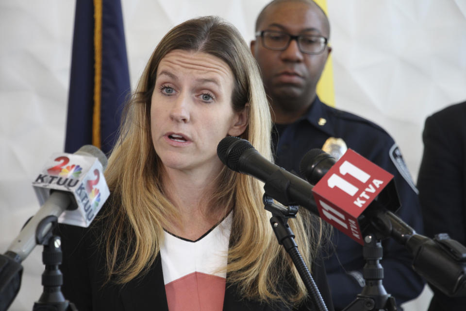 Brittany Dunlop, a deputy district attorney, addresses reporters Thursday, Oct. 17, 2019, in Anchorage, Alaska, after a man accused of documenting the assault and death of Kathleen Henry in a hotel room on a memory card was indicted in a second death. A grand jury on Oct. 17 also indicted Brian Steven Smith in the death of Veronica Abouchuk. (AP Photo/Mark Thiessen)