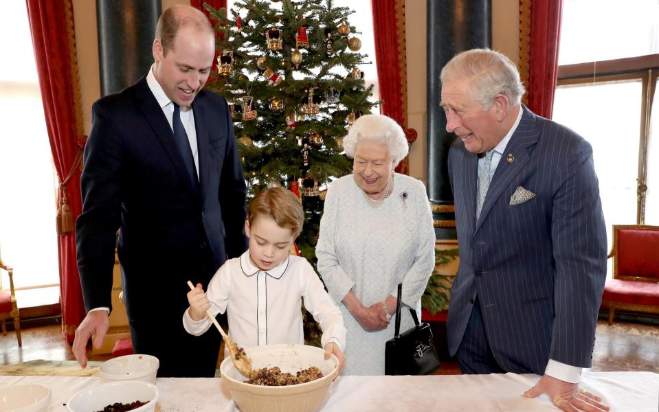Prince William, Duke of Cambridge, Prince George, Queen Elizabeth II and Prince Charles, Prince of Wales prepare special Christmas puddings in the Music Room at Buckingham Palace - Chris Jackson/Buckingham Palace/Getty Images Europe 