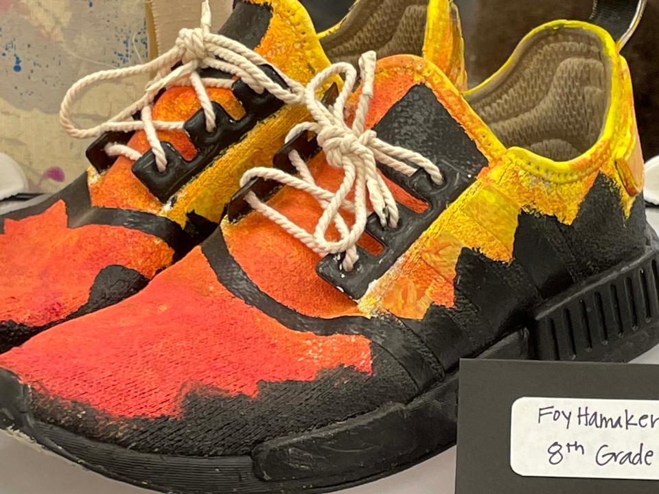 Eighth-grader Foy Hamaker turned his shoes into a flaming sculpture with acrylic paint for the annual Fine Arts Night held at Hardin Valley Middle School Tuesday, April 12, 2022.