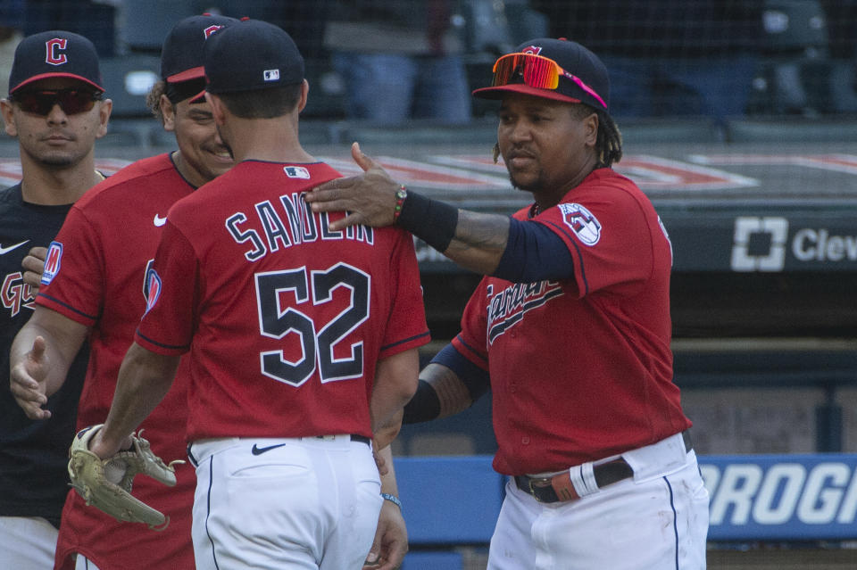 Cleveland Guardians' Jose Ramirez, right, gives Nick Sandlin (52) a pat on the back after a baseball game against the Texas Rangers in Cleveland, Sunday, Sept. 17, 2023. (AP Photo/Phil Long)