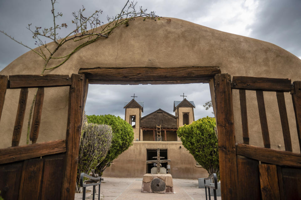 An exterior view of the Santuario de Chimayo, in Chimayo, New Mexico, Friday, April 14, 2023. An estimated 500 Catholic mission churches remain in northern New Mexico, where the Rocky Mountains taper off into desert mesas to the west and endless plains to the east. (AP Photo/Roberto E. Rosales)