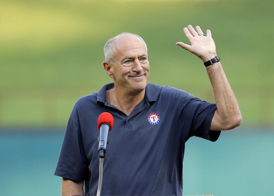 FILE - Texas Rangers radio sports announcer Eric Nadel waves to cheering fans as he emcees a ceremony honoring Adrian Beltre before a baseball game against the New York Yankees, Sept. 8, 2017, in Arlington, Texas. Hall of Fame broadcaster Nadel returned to the Rangers radio booth Friday, Aug. 4, 2023, night to call his first game of the season after he missed AL West-leading Texas' first 109 games while taking time to get treatment for some mental healthy issues. (AP Photo/Tony Gutierrez, File)