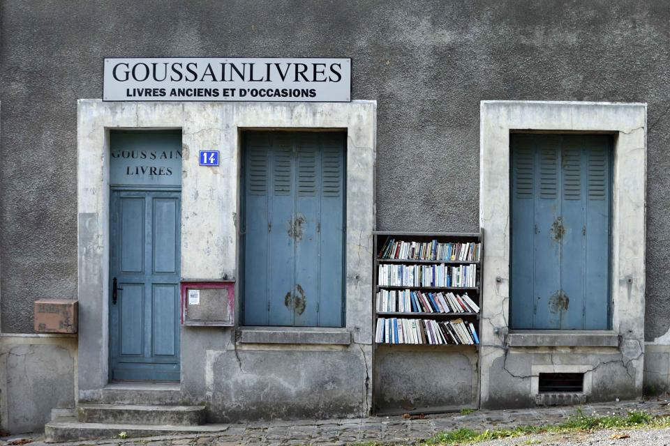 Free books are displayed outside a book shop. The houses are boarded up, the church bells no longer ring out and the town squares are now deserted. (Reuters)
