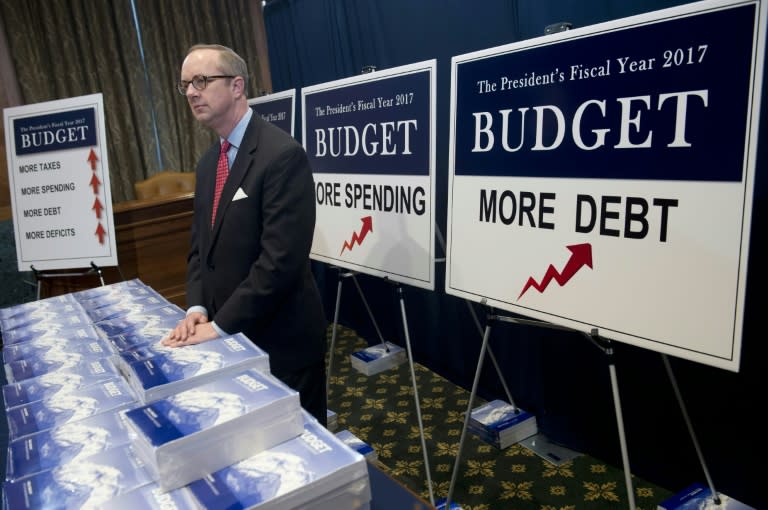 Eric Ueland of the Senate Budget Committee distributes copies of US President Barack Obama's Fiscal Year 2017 budget on Capitol Hill in Washington, DC, February 9, 2016