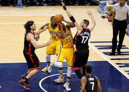 Apr 21, 2016; Indianapolis, IN, USA; Indiana Pacers center Myles Turner (33) takes a shot against Toronto Raptors center Jonas Valanciunas (17) in the second half in game three of the first round of the 2016 NBA Playoffs at Bankers Life Fieldhouse. Toronto defeated Indiana 101-85. Brian Spurlock-USA TODAY Sports
