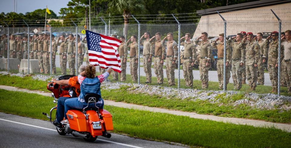 The Warrior Beach Retreat honored wounded veterans with a parade earlier this year, starting in Panama City Beach and ending in Panama City. Service members salute as the parade passes by the Navy base on Thomas Drive.