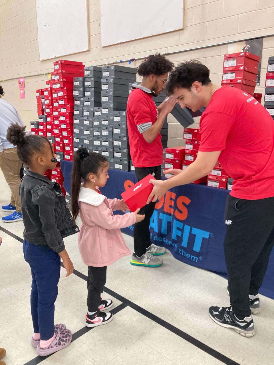 Volunteers with nonprofit Shoes That Fit and New Balance Foundation hand out free sneakers to students at Paragon Mills Elementary in Nashville on March 21, 2024