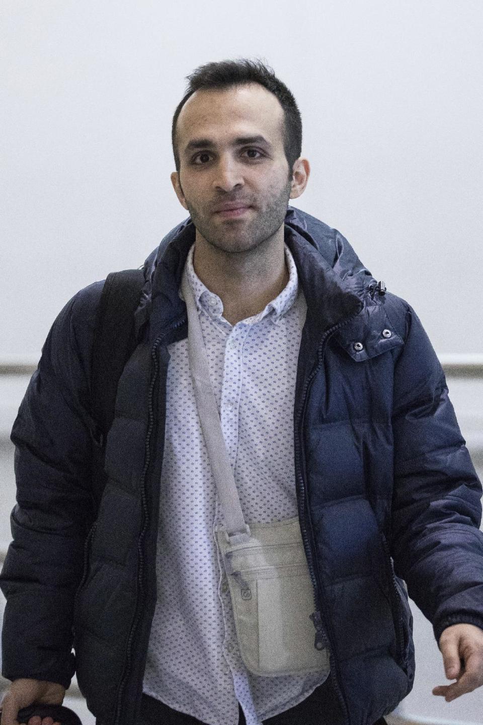 Iranian bioengineering researcher Nima Enayati walks out of a gate after arriving at John F. Kennedy International Airport in New York, Sunday, Feb. 5, 2017. The Ph.D. candidate at a university in Milan was prevented from boarding a flight to the U.S. on Jan. 30. He had a visa to conduct research on robotic surgery at Stanford University in California. (AP Photo/Alexander F. Yuan)