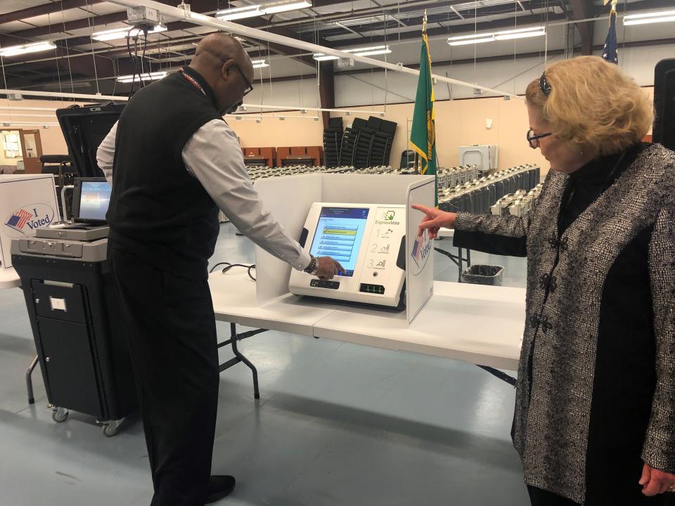 Employees of the Shelby County Election Commission demonstrate how to use a ballot marking device.