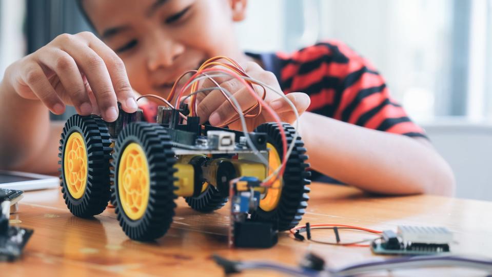 A young boy works on a robotics project.