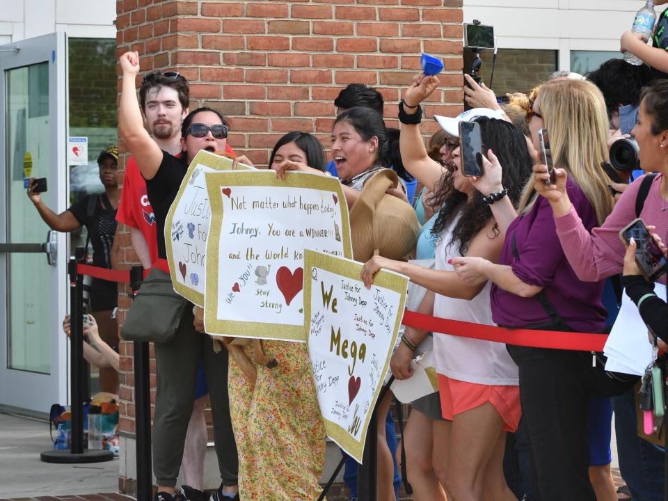 Fans gather outside the Fairfax County Circuit Courthouse in Fairfax, Virginia, on June 1, 2022, after a verdict was reached in the Depp v. Heard defamation trial.