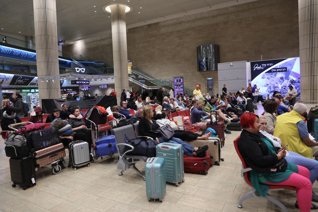 Passengers wait at Ben Gurion Airport near Tel Aviv, Israel, on Oct. 7, as flights are canceled because of the Hamas surprise attack.