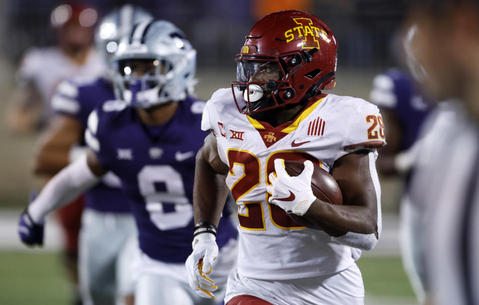 Iowa State running back Breece Hall (28) rushes for a first down as he is chased by Kansas State defenders during the fourth quarter of an NCAA college football game on Saturday, Oct. 16, 2021, in Manhattan, Kan. (AP Photo/Colin E. Braley)