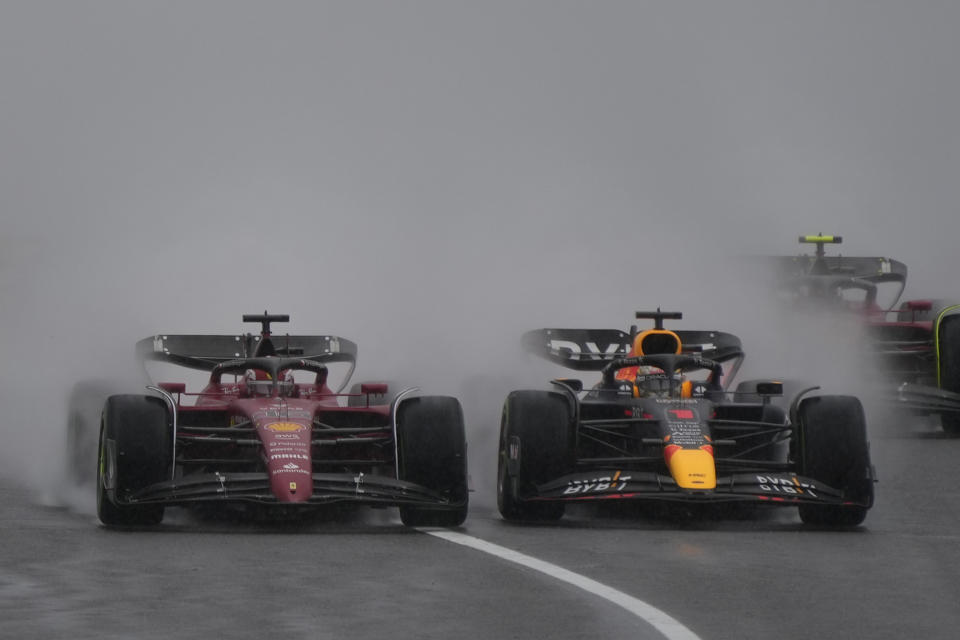 Red Bull driver Max Verstappen, right, of the Netherlands and Ferrari driver Charles Leclerc of Monaco compete in the rain during the Japanese Formula One Grand Prix at the Suzuka Circuit in Suzuka, central Japan, Sunday, Oct. 9, 2022. (AP Photo/Eugene Hoshiko)