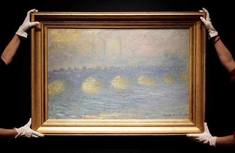 Christie's auction house employees prepare to exhibit a painting by French artist Claude Monet entitled "Waterloo Bridge" at the auction house in London, on June 14, 2007