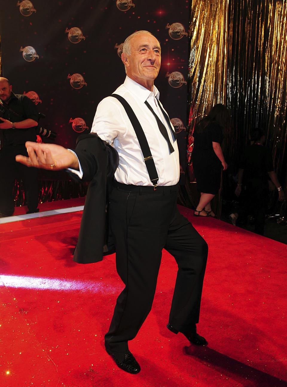 FILE - Len Goodman poses as he arrives for the Strictly Come Dancing Photocall at Elstree Studios, London, Sept 3, 2013. Len Goodman, an urbane long-serving judge on “Dancing with the Stars” and “Strictly Come Dancing,” has died, his agent said Monday, April 24, 2023. He was 78. A former dancer, Goodman was a judge on “Strictly Come Dancing” for 12 years from its launch on the BBC in 2004. (Ian West/PA via AP, File)