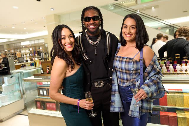 <p>Courtesy Neiman Marcus</p> Brie Garcia, Trevon Diggs and Nikki Garcia