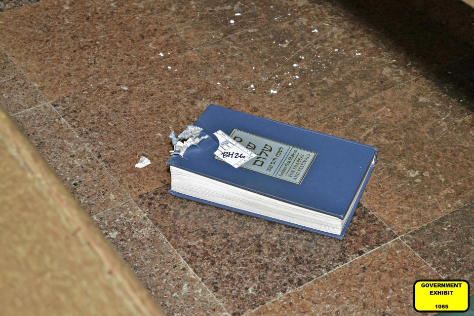 This photo of bullet-damaged prayer book in the Tree of Life synagogue building in Pittsburgh was entered May 30, 2023, as a court exhibit by prosecutors in the federal trial of Robert Bowers. He faces multiple charges in the killing of 11 worshippers from three congregations and the wounding of seven worshippers and police officers in the building on Oct. 27, 2018. The charges include the obstruction of the free exercise of religion, resulting in death. (U.S. District Court for the Western District of Pennsylvania via AP)