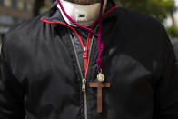 A man stays in front of the main gate of La Sed church after an Easter Holy Week procession was cancelled due to the coronavirus outbreak in Seville, Spain, Thursday, April 9, 2020. The COVID-19 coronavirus causes mild or moderate symptoms for most people, but for some, especially older adults and people with existing health problems, it can cause more severe illness or death. (AP Photo/Laura Leon)