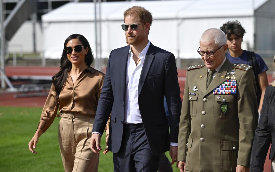 Meghan wore a L’Agence blouse, Gabriela Hearst trousers and Miu Miu sunglasses on Thursday