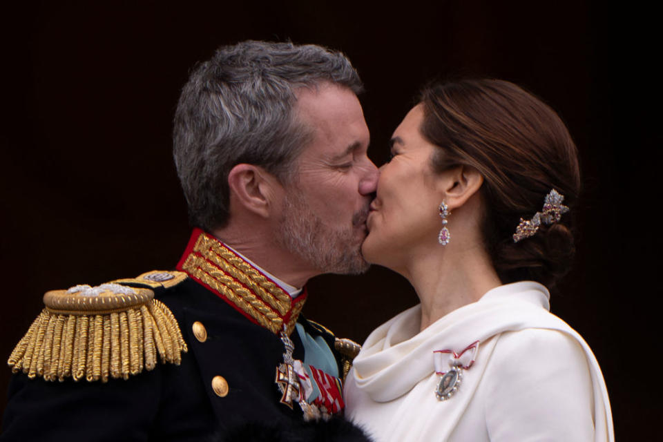 King Frederik X of Denmark kisses Queen Mary on the royal balcony