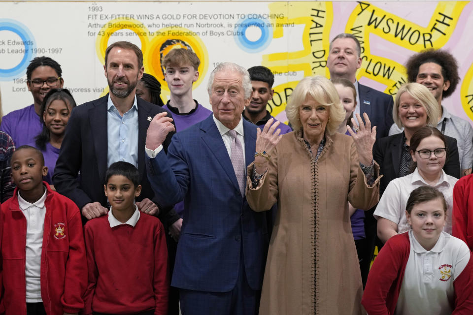 FILE - Britain's King Charles III, center, and Camilla, the Queen Consort, center right, pose for a photograph with England's national soccer coach and Prince's Trust ambassador Gareth Southgate, left, and children from St Peter's Primary School, during a visit to the Norbrook Community Centre, Wythenshawe, in Manchester, England, Friday Jan. 20, 2023. (AP Photo/Frank Augstein, Pool, File)