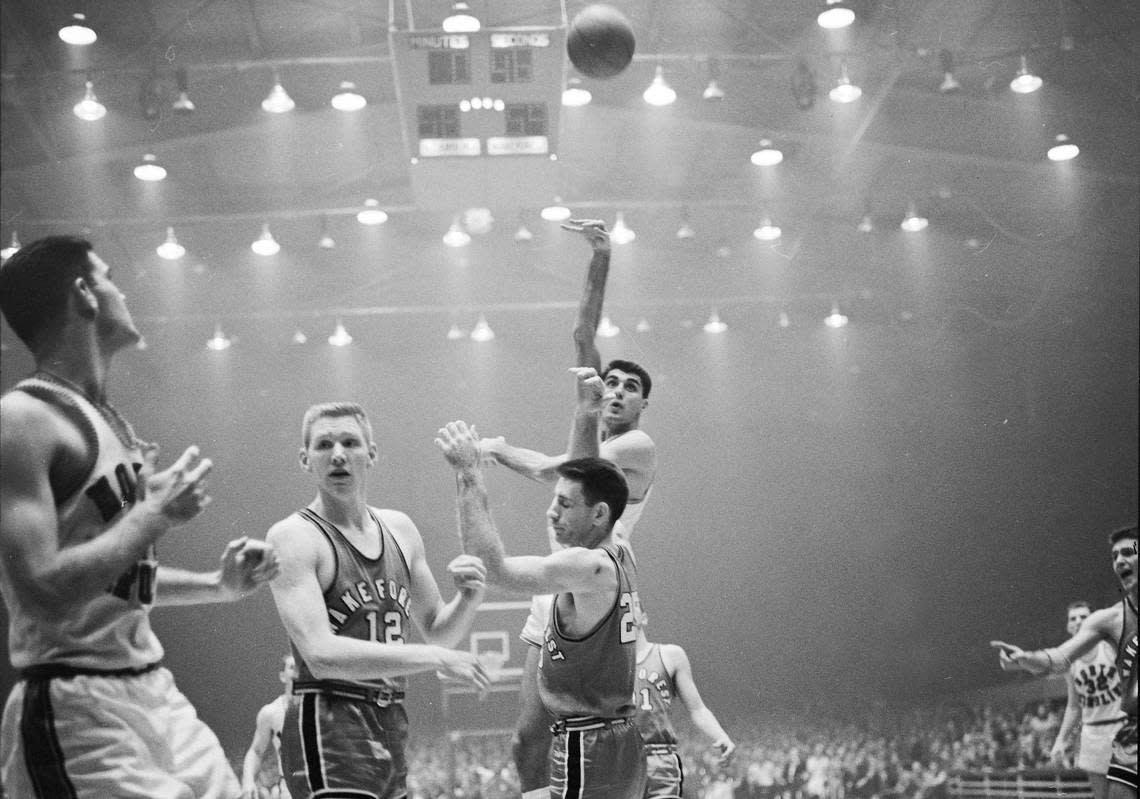 UNC’s Lennie Rosenbluth shoots over Wake Forest during action in the 1957 ACC Tournament in a smoky Reynolds Coliseum.