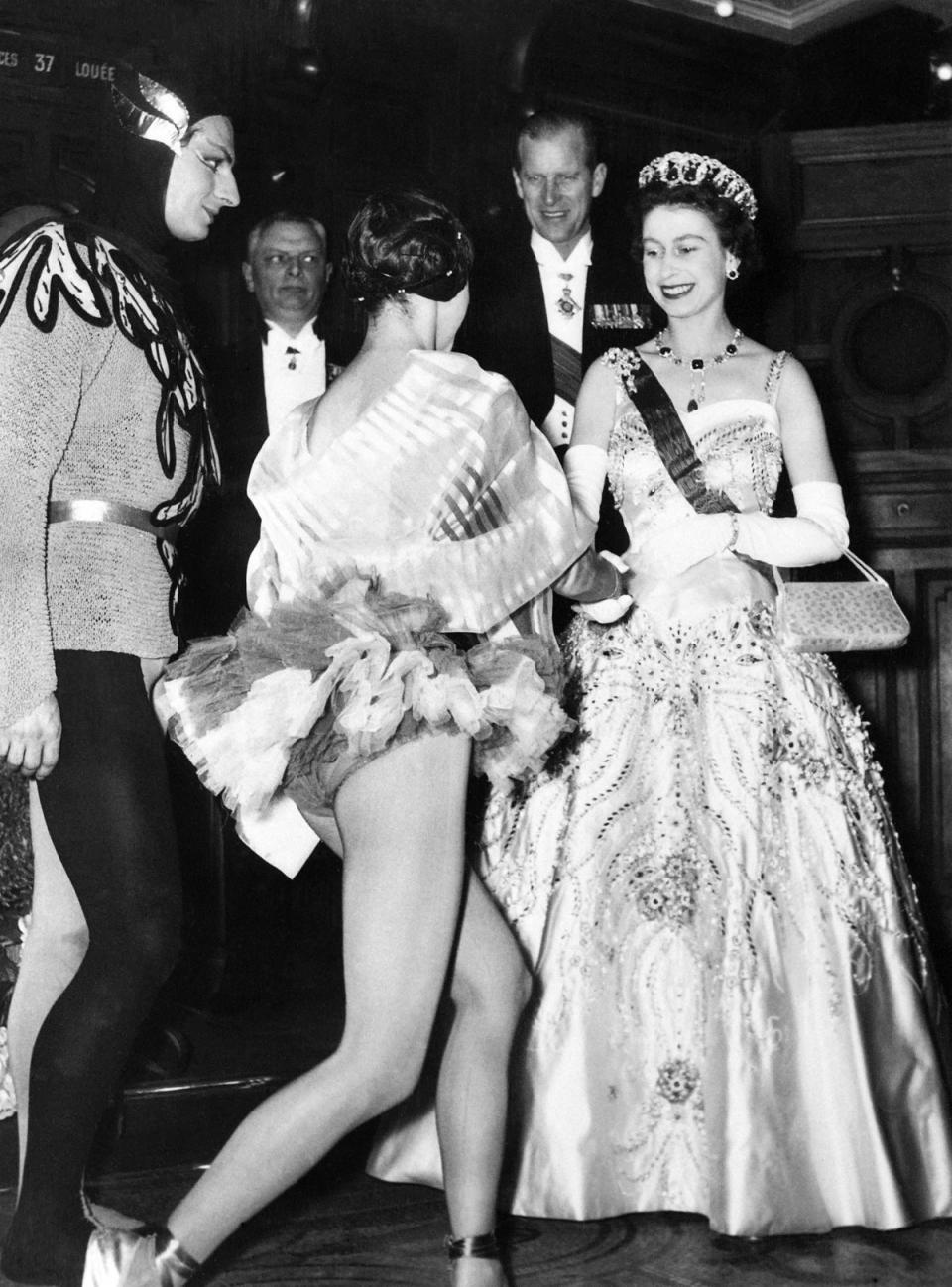 Queen Elizabeth II and Duke of Edinburgh greet French dancers Lyane Dayde and Michel Renault at the Opera Garnier in Paris during a state visit in France on April 9, 195 (AFP via Getty Images)