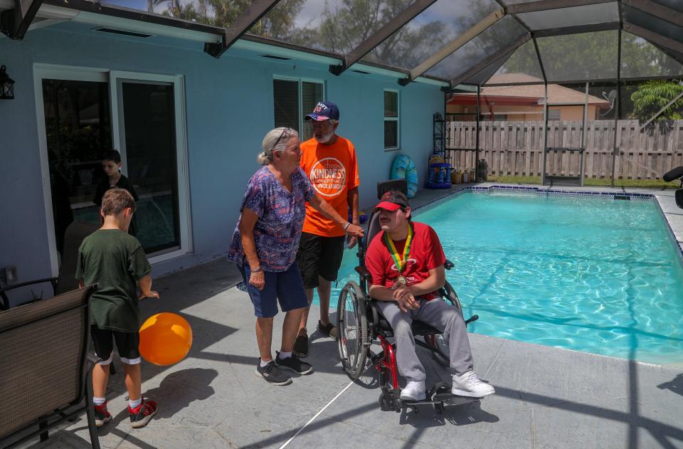 Paul and Veronica Herbs, son Joshua, right, and grandchildren Sebastian Slattery, 10, and Malaki Slattery, 8, stand  in front of their refinished pool on Wednesday.