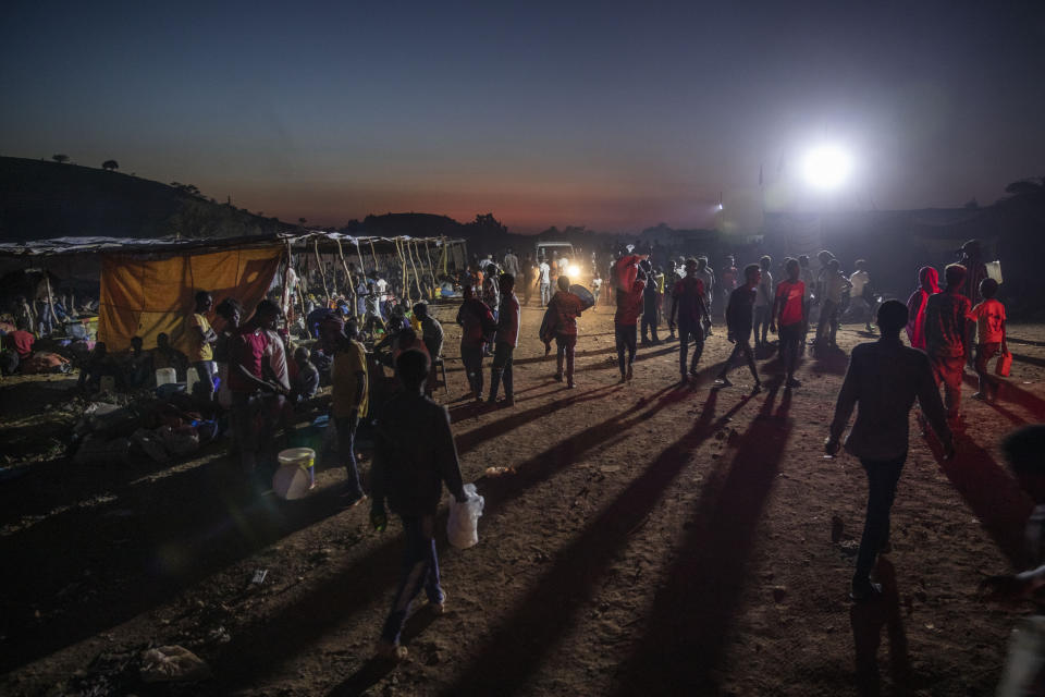 Tigray people who fled the conflict in Ethiopia's Tigray region, walk at Umm Rakouba refugee camp in Qadarif, eastern Sudan, Wednesday, Nov. 25, 2020. Misery continues for the refugees in Sudan, with little food, little medicine, little shelter, little funding and little or no contact with loved ones left behind in Tigray. (AP Photo/Nariman El-Mofty)