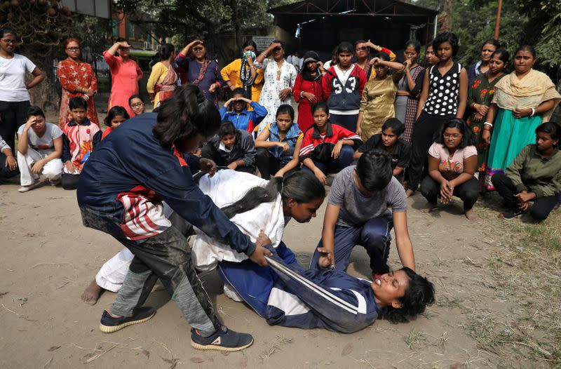 Girls practice a self-defense technique at a training camp in Kolkata