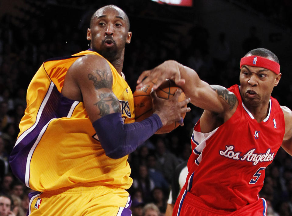 Los Angeles Clippers' Caron Butler, right, attempts to knock the ball away from Los Angeles Lakers' Kobe Bryant during the first half of an NBA preseason basketball game in Los Angeles on Monday, Dec. 19, 2010. (AP Photo/Danny Moloshok)