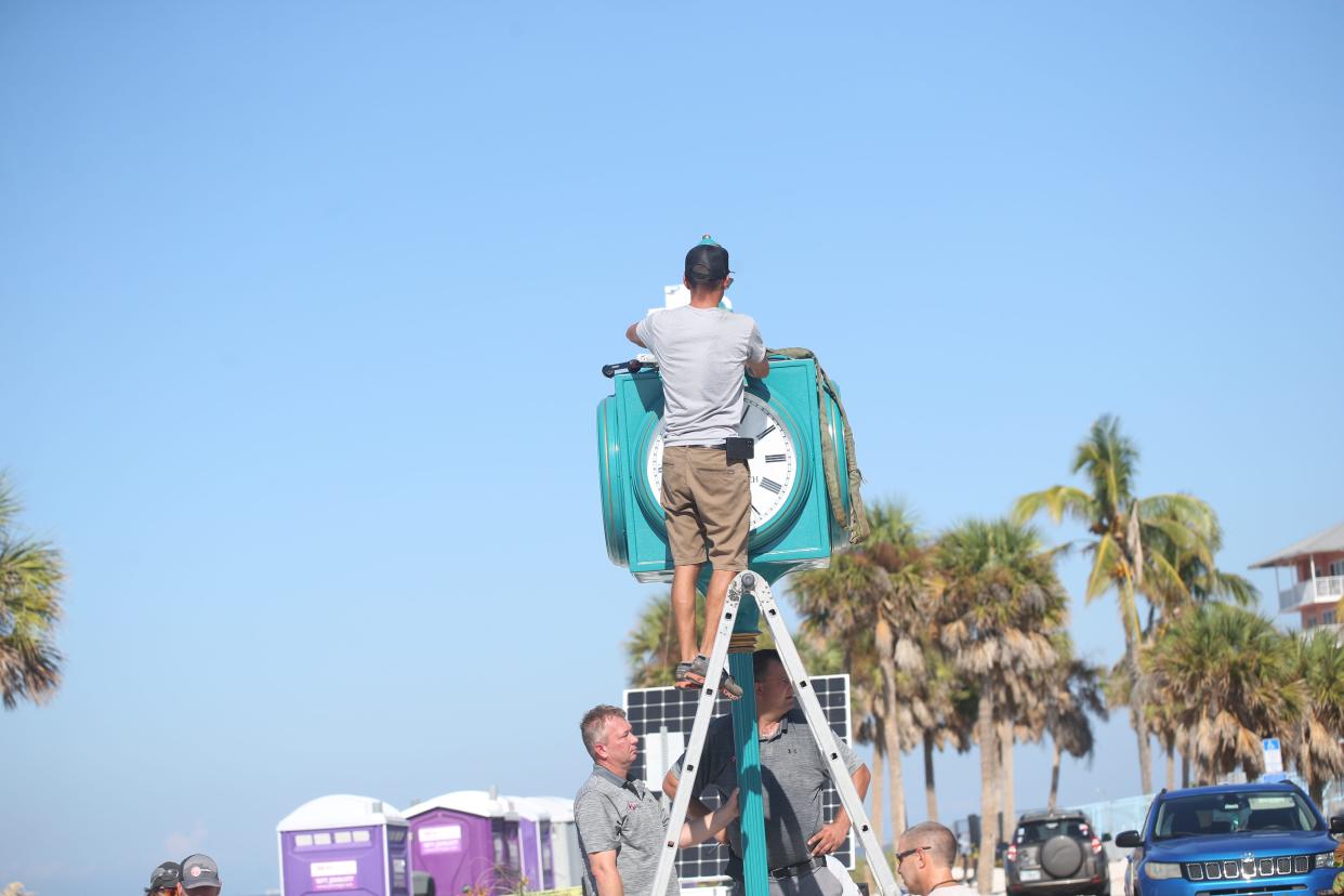 Crews with the Verdin Company and Kell]y General Contracting install the new clock in Times Square on Fort Myers Beach on Thursday, Sept. 14, 2023. The original clock was destroyed after Hurricane Ian decimated the island on Sept. 28, 2022 . The clock will be covered until it is unveiled during a ceremony on Sept. 28, 2023.