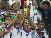 Germany's captain Philipp Lahm lifts the World Cup trophy after the 2014 World Cup final against Argentina at the Maracana stadium in Rio de Janeiro July 13, 2014. REUTERS/Eddie Keogh (BRAZIL - Tags: SOCCER SPORT WORLD CUP)